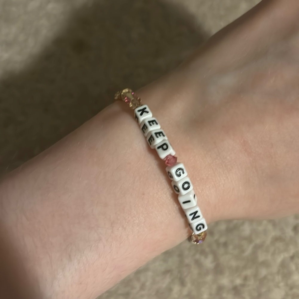 Little Words Project bracelet that says keep going worn once